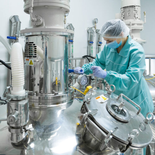 Pharmaceutical technician in sterile environment at pharmacy industry